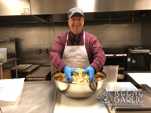 Keene making garlic powder at Madison FEED Kitchen