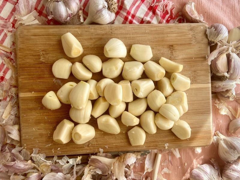 Whole Peeled Cloves on Cutting Board